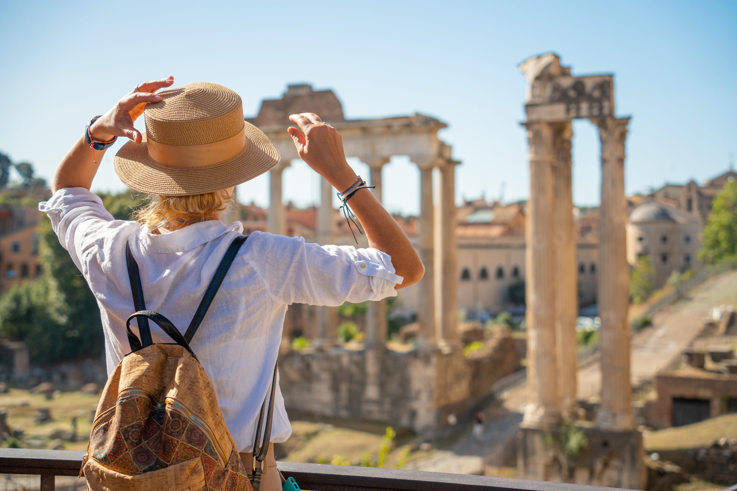Women examines the ruins of the Temple of Saturn in the Roman Forum, Rome, Italy.